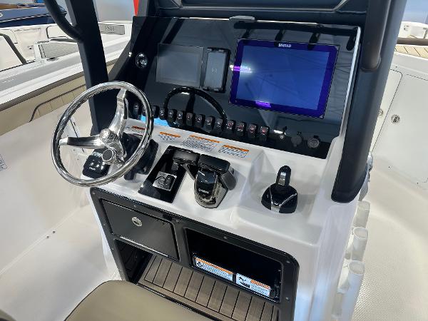 Slide: The Image of 2024 Yamaha Boats 255 FSH Sport H dashboard with steering wheel and control panel. - 11