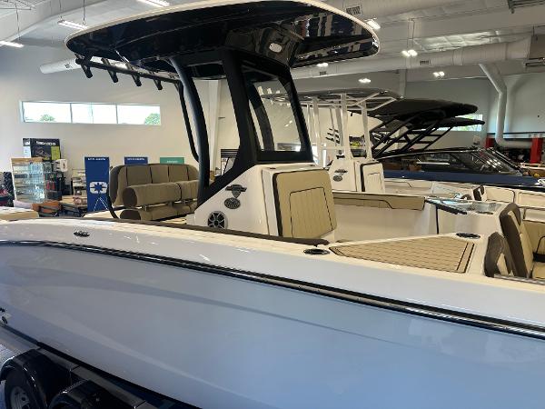 Slide: The Image of 2024 Yamaha Boats 255 FSH Sport H in showroom, sleek design, modern features. - 2