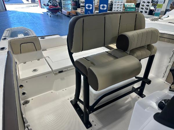 Slide: The Image of 2024 Yamaha Boats 255 FSH Sport H interior seating, featuring beige cushioned seats and sleek design. - 21