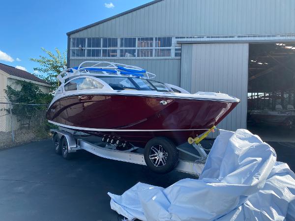Slide: The Image of 2023 Yamaha Boats 275SE in red, parked on a trailer outside a warehouse. - 3