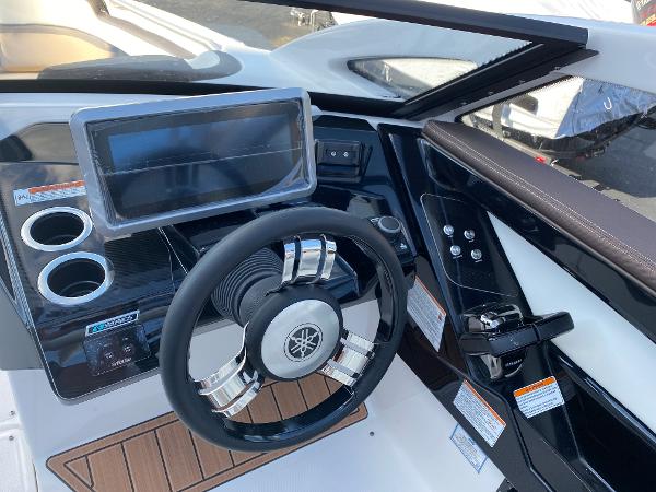 Slide: The Image of 2023 Yamaha Boats 275SE dashboard with steering wheel and touchscreen display. - 6