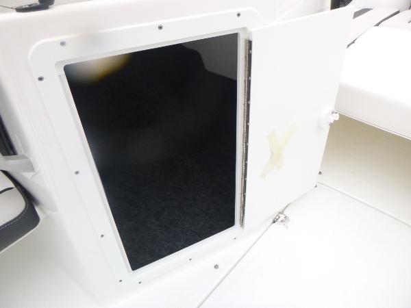 Slide: The Image of 2024 Yamaha AR195 boat storage compartment with open door. - 12