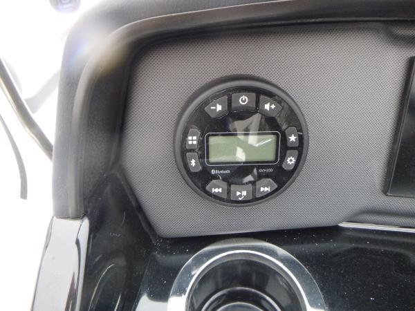 Slide: The Image of 2024 Yamaha Boats AR195 dashboard with control panel and cup holder. - 16