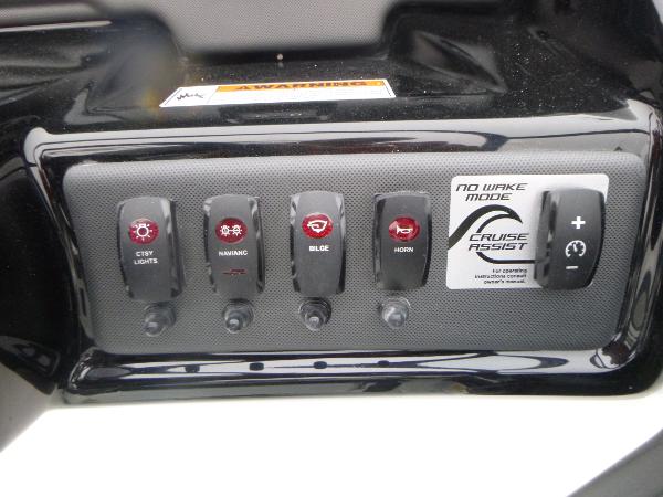 Slide: The Image of Control panel of 2024 Yamaha Boats AR195 with various switches and cruise assist feature. - 17