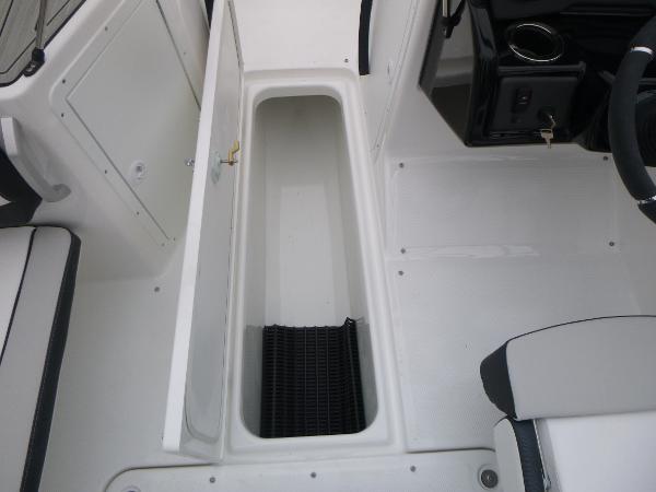 Slide: The Image of 2024 Yamaha AR195 boat interior storage compartment with open hatch. - 21