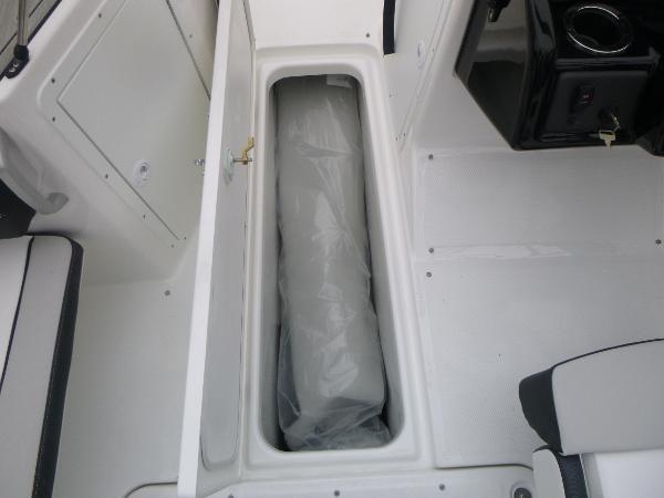 Slide: The Image of 2024 Yamaha AR195 boat storage compartment with cushioned interior. - 22