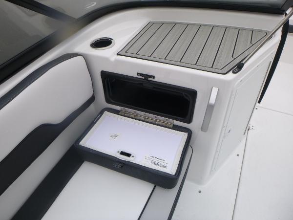 Slide: The Image of 2024 Yamaha AR195 boat interior with storage compartment and cup holder. - 24