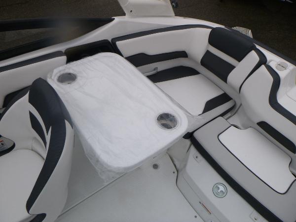Slide: The Image of 2024 Yamaha AR195 boat interior with white and black seating and table. - 26