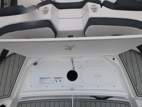 Slide: The Image of 2024 Yamaha AR195 boat interior storage compartment with seating and deck view. - 34