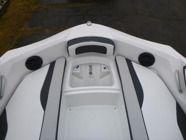 Slide: The Image of 2024 Yamaha Boats AR195 bow seating area with speakers and storage. - 6