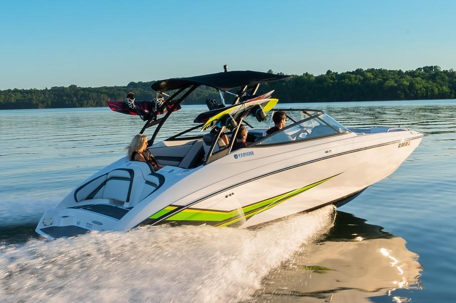 Slide: The Image of 2019 Yamaha AR240 boat cruising on a serene lake with passengers. - 14