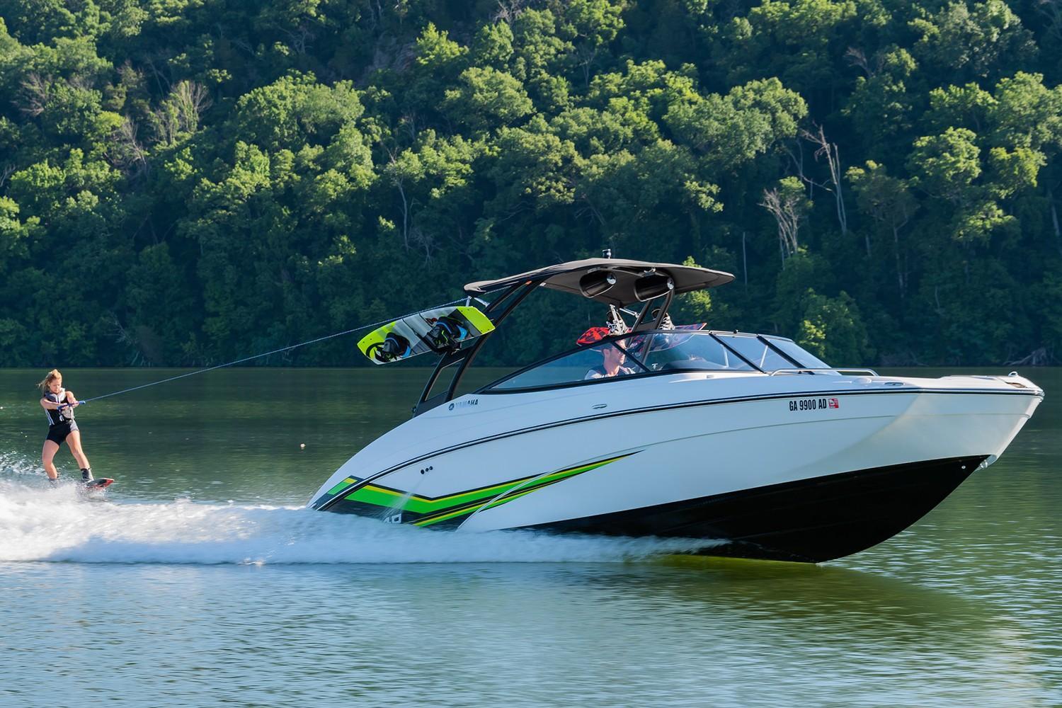 Slide: The Image of 2019 Yamaha AR240 boat towing a wakeboarder on a scenic lake. - 16