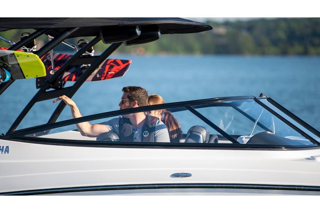 Slide: The Image of 2019 Yamaha Boats AR240 on water, with passengers enjoying a sunny day. - 21
