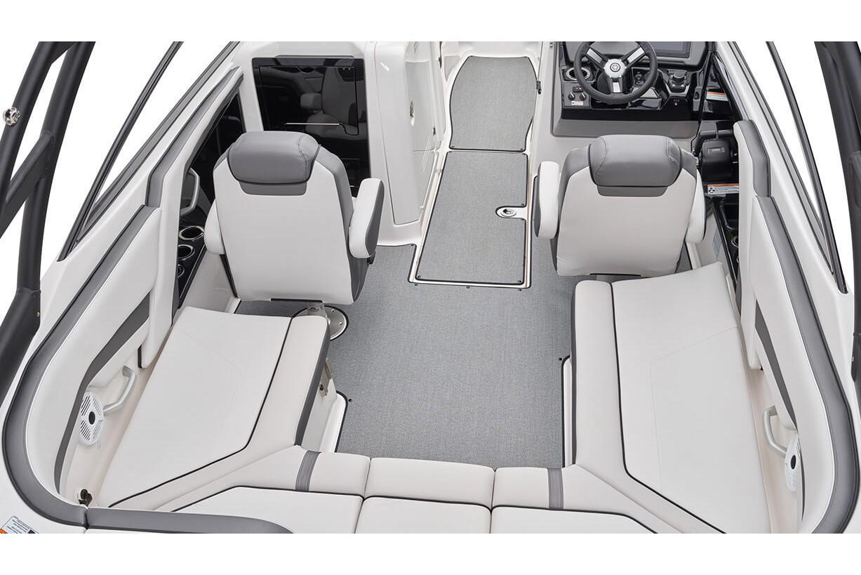 Slide: The Image of 2019 Yamaha AR240 boat interior with gray seating and steering console. - 25