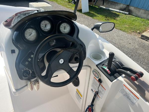 Slide: The Image of 2000 Yamaha LS 2000 boat dashboard with steering wheel and control panel. - 14
