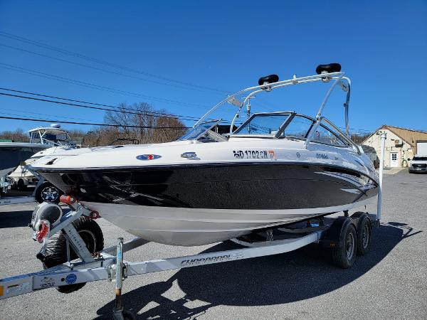 Slide: The Image of 2007 Yamaha SX210 boat on trailer, black and white design, parked outdoors. - 1