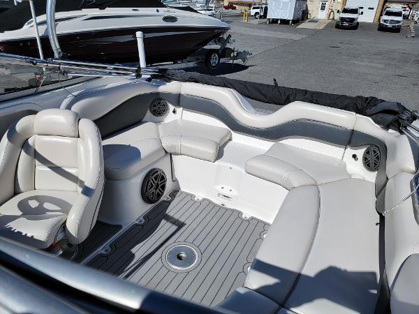 Slide: The Image of 2007 Yamaha Boats SX210 interior with gray and white seating in a marina setting. - 11