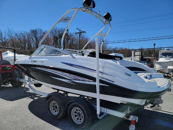 Slide: The Image of 2007 Yamaha SX210 boat on trailer, sleek design, twin engines, sunny day. - 2
