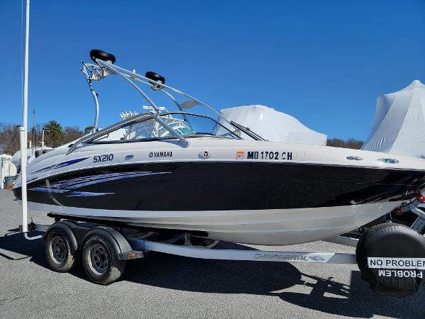 Slide: The Image of 2007 Yamaha SX210 boat on trailer, black and white design, parked outdoors. - 3