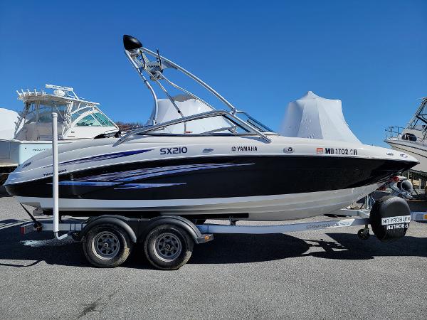 Slide: The Image of 2007 Yamaha SX210 boat on trailer, black and white design, parked outdoors. - 4
