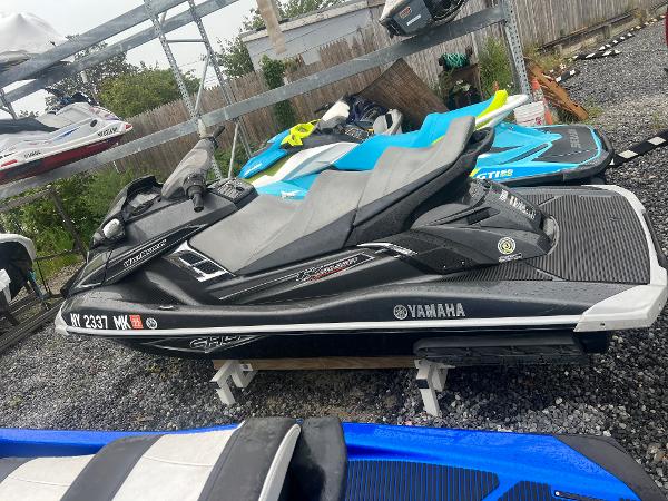 Slide: The Image of 2013 Yamaha WaveRunner FX Cruiser SHO jet ski in black, parked on gravel. - 2