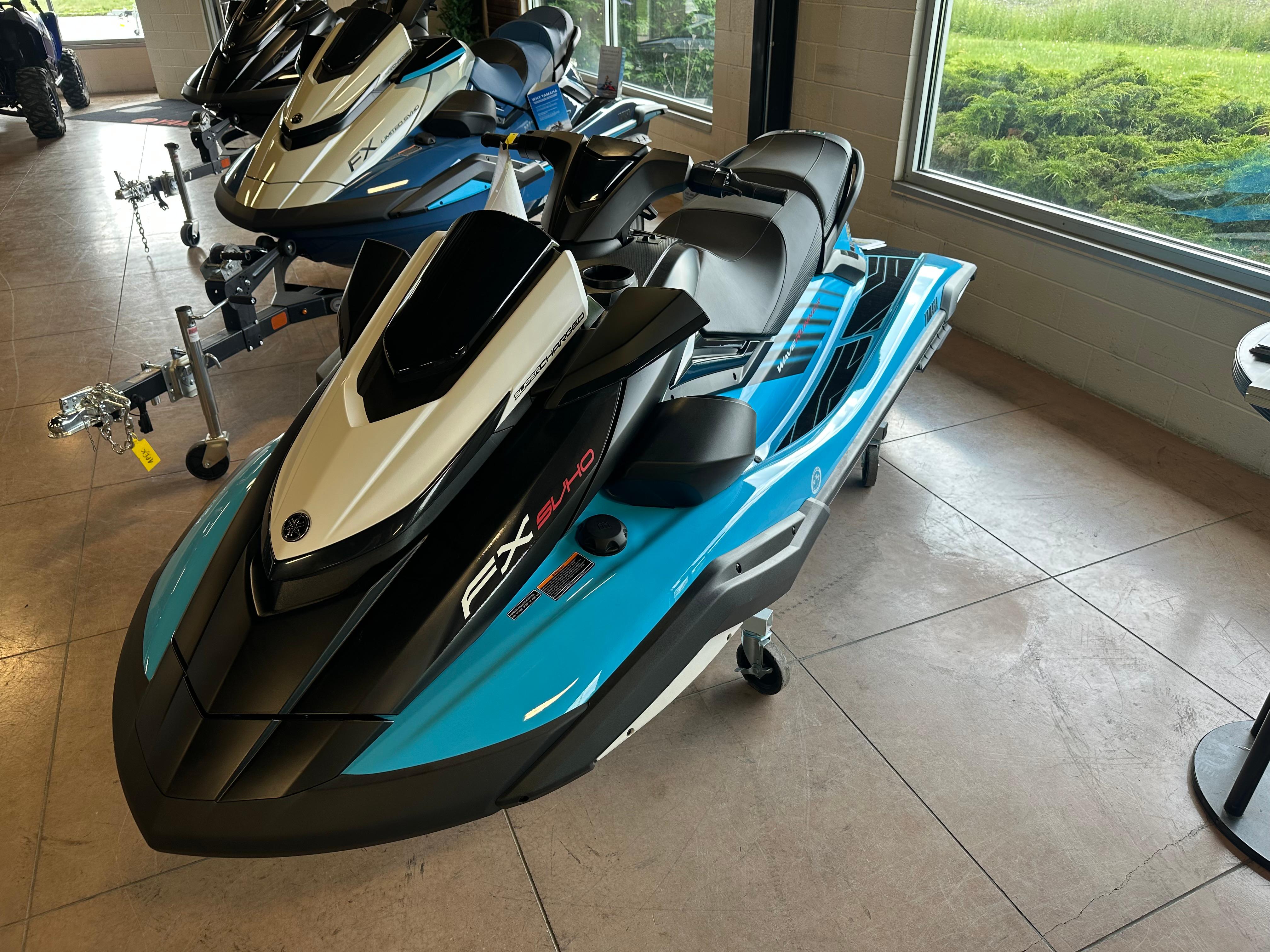 The Image of 2025 Yamaha WaveRunner FX SVHO in showroom, sleek design, blue and black color scheme. - 1
