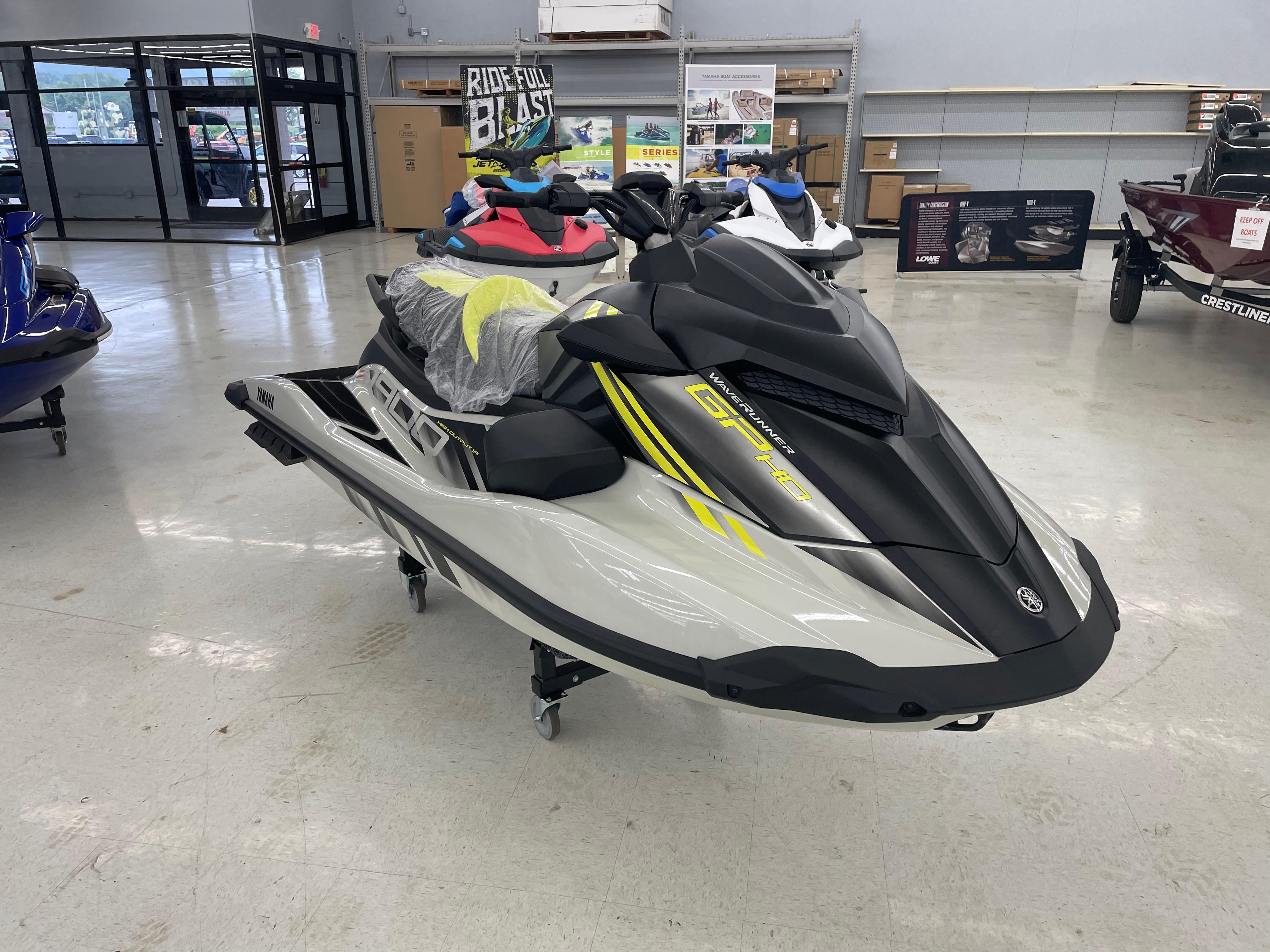 Slide: The Image of 2025 Yamaha WaveRunner GP HO in showroom, sleek design with yellow accents. - 1