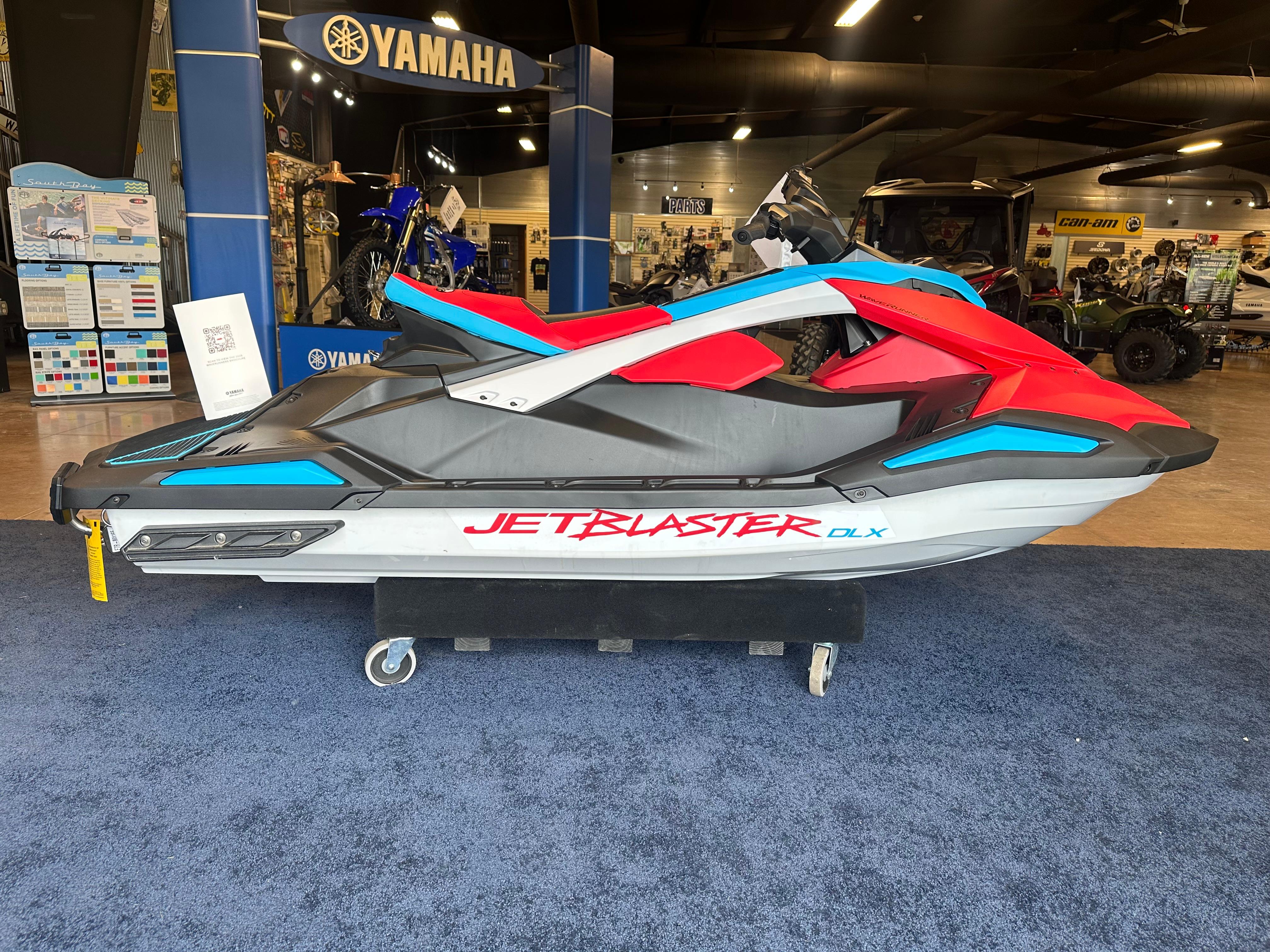 The Image of 2025 Yamaha WaveRunner JetBlaster DLX 2-Up in showroom, vibrant red and blue design. - 0