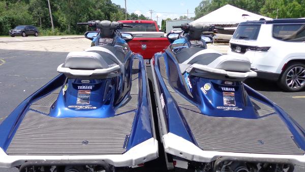 Slide: The Image of 2015 Yamaha WaveRunner VX Cruiser jet skis parked side by side in a lot. - 4