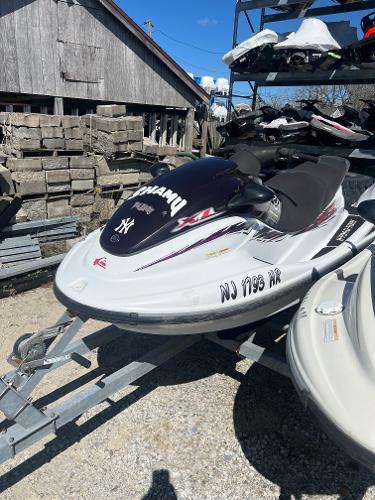 Slide: The Image of 1999 Yamaha WaveRunner XL 1200 jet ski on a trailer in a storage yard. - 1