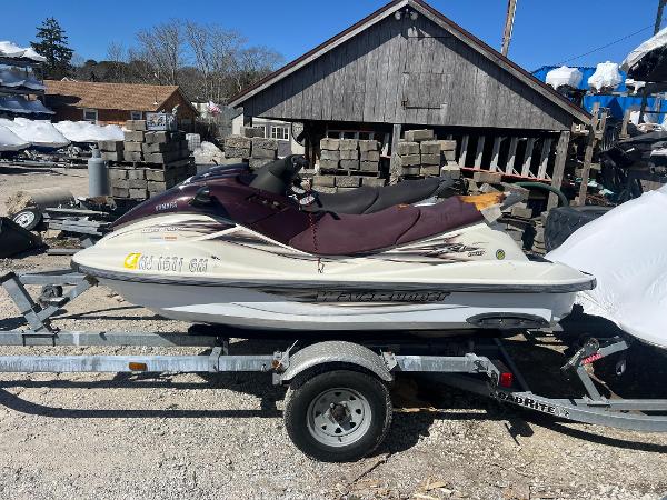 Slide: The Image of 2000 Yamaha WaveRunner XL 800 on trailer, parked outdoors near wooden building. - 10