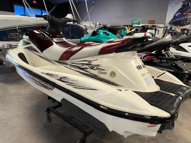 Slide: The Image of 2000 Yamaha WaveRunner XL 800 jet ski in showroom, featuring sleek design and maroon accents. - 4