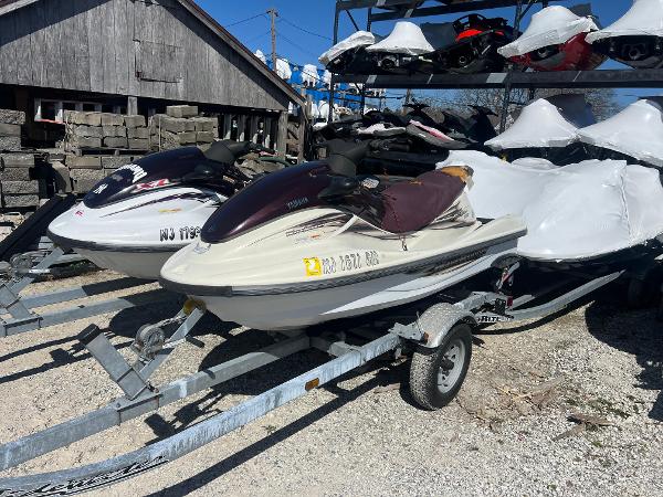 Slide: The Image of 2000 Yamaha WaveRunner XL 800 on trailer, parked outdoors with other jet skis. - 6