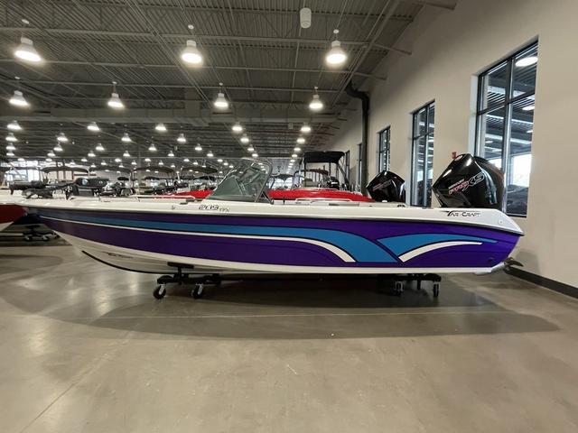 Slide: The Image of 2023 Yar-Craft 209 TFX boat in showroom, purple and blue design. - 0