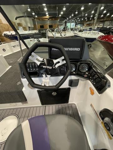 Slide: The Image of 2023 Yar-Craft 209 TFX boat cockpit with steering wheel and Humminbird electronics. - 8