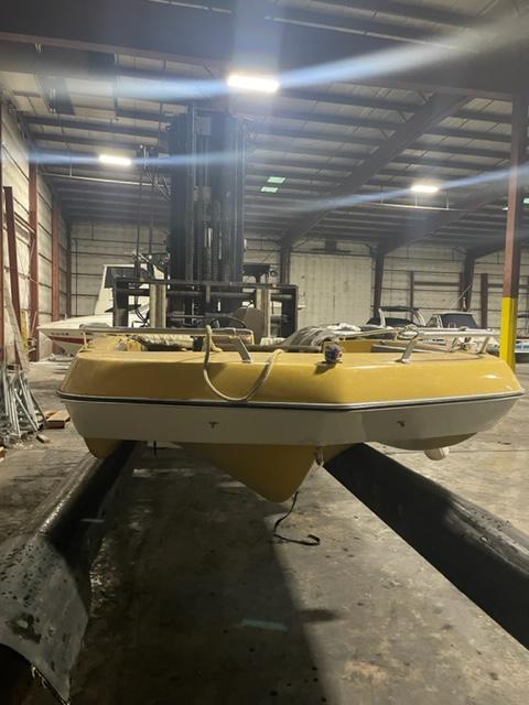 Slide: The Image of 1977 Yarcraft Spirit of 76 boat in warehouse, yellow hull, industrial setting. - 5