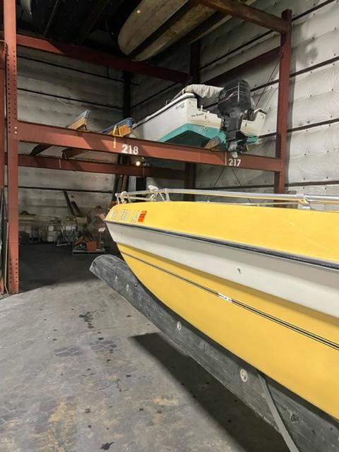 Slide: The Image of Yellow 1977 Yarcraft Spirit of 76 boat stored indoors on a rack. - 6