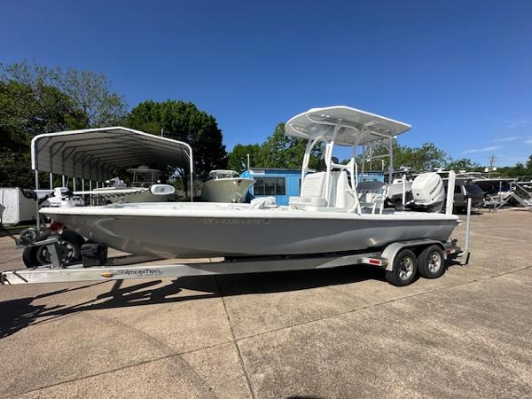 Slide: The Image of 2020 Yellowfin 24 Bay CE boat on trailer, parked outdoors under clear blue sky. - 0