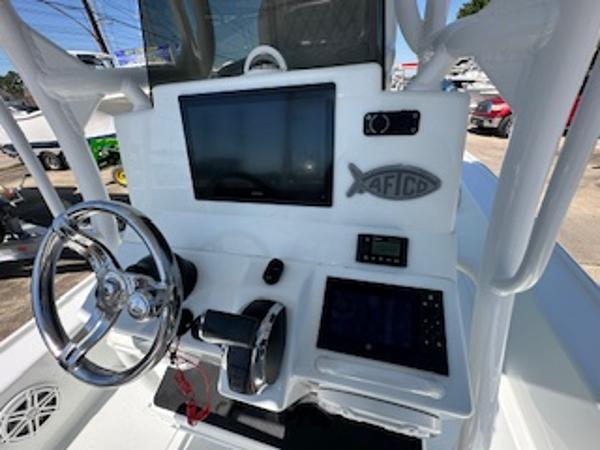 Slide: The Image of 2020 Yellowfin 24 Bay CE boat dashboard with steering wheel and electronic displays. - 11