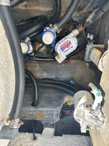 Slide: The Image of 2020 Yellowfin 24 Bay CE boat engine compartment with hoses and filters. - 17