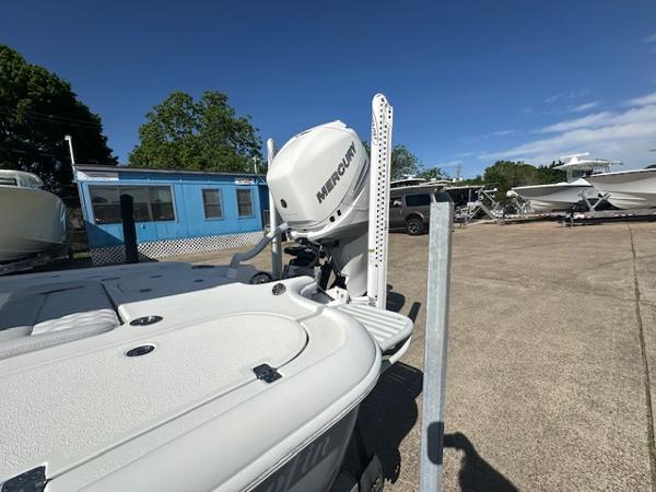 Slide: The Image of 2020 Yellowfin 24 Bay CE boat with Mercury engine in a sunny outdoor setting. - 6