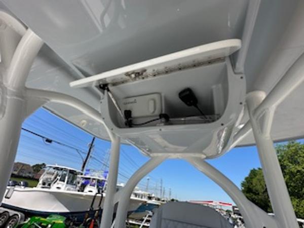 Slide: The Image of 2020 Yellowfin 24 Bay CE boat interior, showcasing overhead storage and equipment. - 9