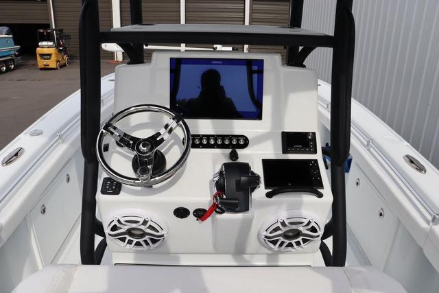Slide: The Image of 2025 Yellowfin 26 Hybrid boat console with steering wheel, electronics, and speakers. - 16
