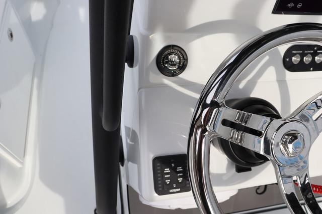 Slide: The Image of 2025 Yellowfin 26 Hybrid boat steering wheel and control panel close-up. - 20