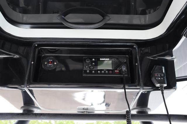 Slide: The Image of 2025 Yellowfin 26 Hybrid boat console with Simrad electronics and communication equipment. - 22