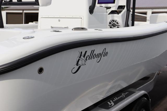 Slide: The Image of 2025 Yellowfin 26 Hybrid boat, sleek white design with logo, on a trailer. - 4