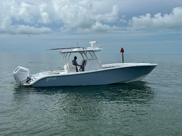 Slide: The Image of 2025 Yellowfin 32 boat on calm ocean waters under cloudy sky. - 0