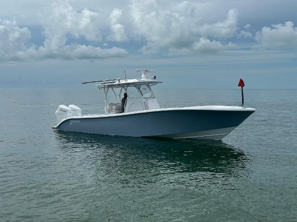 Slide: The Image of 2025 Yellowfin 32 boat on calm ocean waters under cloudy sky. - 1