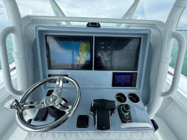 Slide: The Image of 2025 Yellowfin 32 boat dashboard with dual screens and steering wheel. - 11