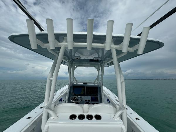 Slide: The Image of 2025 Yellowfin 32 boat console with rod holders on a cloudy day. - 13